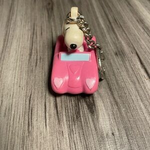 collectible Snoopy and Woodstock PVC 
Key chain featuring snoopy driving